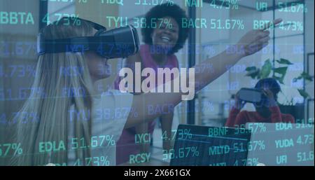 Image of trading board over diverse female coworkers testing vr headsets in office Stock Photo
