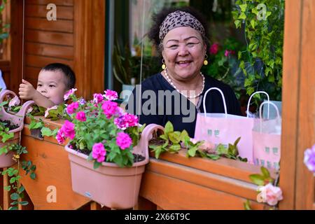 Yining, China's Xinjiang Uygur Autonomous Region. 11th May, 2024. Tourists enjoy themselves on Liuxing Street in Yining City, Ili Kazak Autonomous Prefecture, northwest China's Xinjiang Uygur Autonomous Region, May 11, 2024. Credit: Ding Lei/Xinhua/Alamy Live News Stock Photo