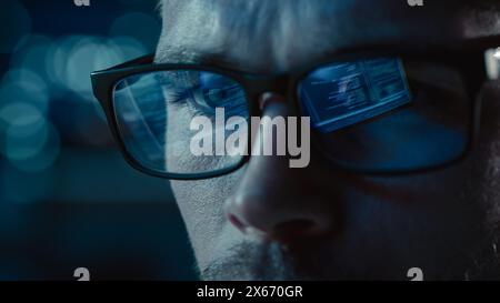 Close-up Portrait of Software Engineer Working on Computer, Line of Code Reflecting in Glasses. Developer Working on Innovative e-Commerce Application using Machine Learning, AI Algorithm, Big Data Stock Photo