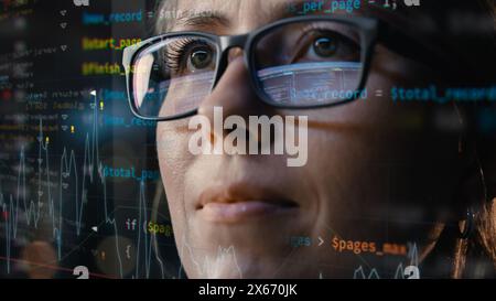 Close-up Portrait of Female Software Engineer Working on Computer, Program Code Run Aroung Her. Developer Working on Innovative e-Commerce Application using Machine Learning, AI, Big Data Stock Photo