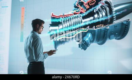 Innovative Green Energy Startup: Engineer Designing Engine Using Tablet Computer and Big Wall Screen to Analyse Prototype. Concept for Sustainable Environmnetally Friendly Zero Emissions Turbine Stock Photo
