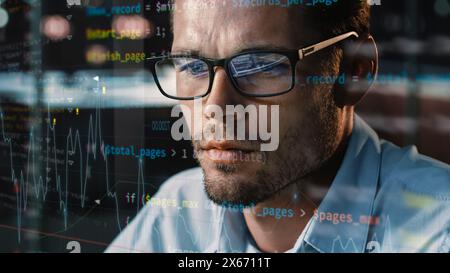 Close-up Portrait of Software Engineer Working on Computer, Line of Code Run Aroung Him. Developer Working on Innovative e-Commerce Application using Big Data Concept Stock Photo
