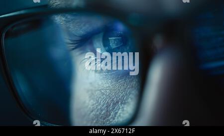Close-up Portrait of Software Engineer Working on Computer, Line of Code Reflecting in Glasses. Developer Working on Innovative e-Commerce Application using Big Data AI. Stylish Macro Shot of Eye Stock Photo