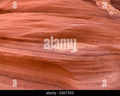 Close up of sandstone walls in Antelope Canyon show the eroded, sculpted geological features formed into the rock from thousands of years of flooding Stock Photo