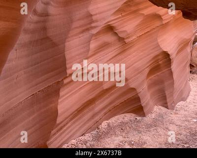 Close up of sandstone walls in Antelope Canyon show the eroded, sculpted geological features formed into the rock from thousands of years of flooding Stock Photo