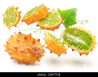Kiwano fruit with kiwano slices levitating in air on white background. Stock Photo