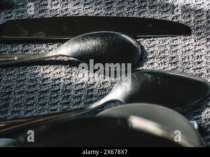 Spoons on a cloth drying by the kitchen sink Stock Photo