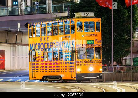 Hong Kong, China - April 6, 2024: Hong Kong Tramway double-decker tram public transport at Des Voeux Rd in Hong Kong, China. Stock Photo