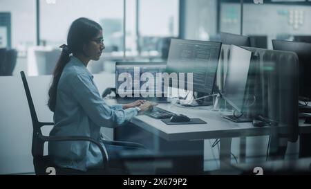Diverse Office: Indian IT Programmer Working on Desktop Computer. Female Specialist Creating Innovative Software. Engineer Developing App, Program, Video Game. Writing Code. Stock Photo