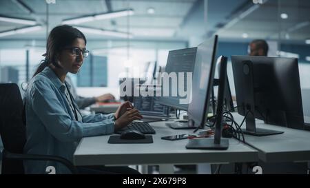 Diverse Office: Indian IT Programmer Working on Desktop Computer. Female Specialist Creating Innovative Software Engineer Developing App, Program, Video Game. Terminal with Coding Language. Stock Photo