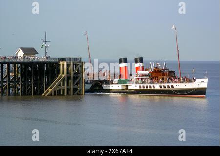 The Waverley paddle steamer stops at Penarth Pier, South Wales during a trip around the Bristol Channel in the evening sun. Stock Photo