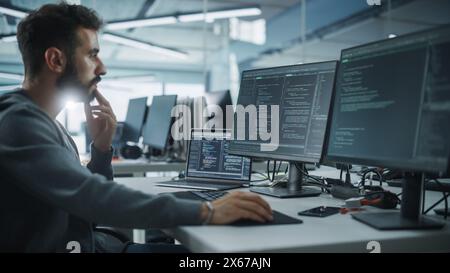 Diverse Office: Enthusiastic White IT Programmer Working on Desktop Computer. Male Specialist Creating Innovative Software. Engineer Developing App, Program, Video Game. Writing Code in Terminal Stock Photo
