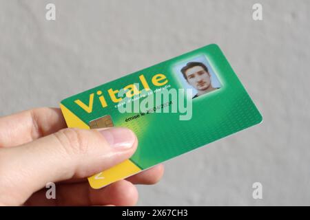 Young man's health insurance card of the national health care system in France, named Carte Vitale (translation 'Vital card') Stock Photo