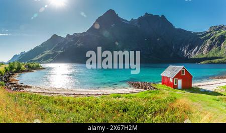 Red boathouse on a fjord in the Lofoten in Norwgen Stock Photo