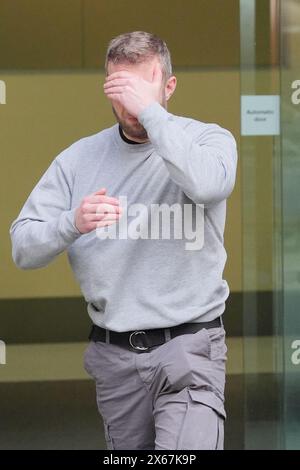 Matthew Trickett covers his face as he leaves Westminster Magistrates' Court, central London, where three men appeared charged under the National Security Act of assisting a foreign intelligence service in Hong Kong. Chi Leung (Peter) Wai, 38, of Staines-upon-Thames, Trickett, 37, of Maidenhead, and Chung Biu Yuen, 63, of Hackney, have each been charged with assisting a foreign intelligence service, contrary to section 3(1) and (9) of the National Security Act 2023. They have also each been charged with foreign interference, contrary to section 13(2) and (7) of the National Security Act 2023.  Stock Photo