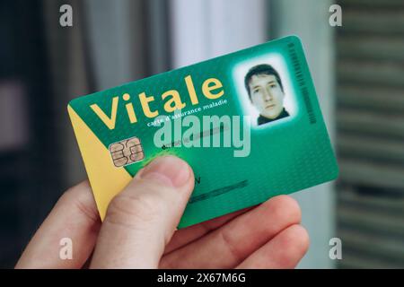 Young man's health insurance card of the national health care system in France, named Carte Vitale (translation 'Vital card') Stock Photo