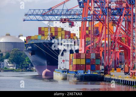 A general cargo ship sails into the port of Qingdao, a port in Shandong ...