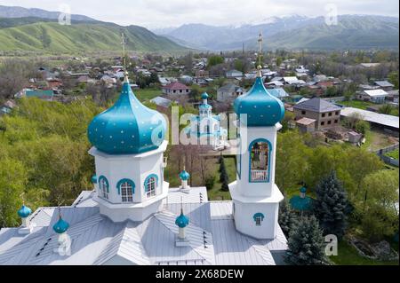 Turgen, Kazakhstan. 23rd Apr, 2024. The orthodox church Khram Arkhangela Mikhaila in front of the high mountains of Transili-Alatau (photo taken with a drone). Credit: Sebastian Kahnert/dpa/Alamy Live News Stock Photo