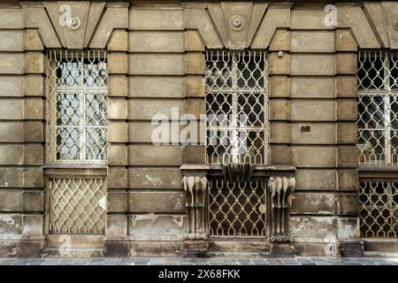 Rectangular windows with a white lattice on the background of an old stone wall. From the Windows of the World series. Stock Photo