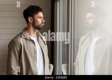 Man Standing in Front of Window at Home Stock Photo