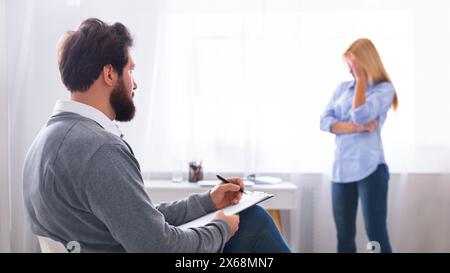 Therapist Taking Notes During a Counseling Session Stock Photo