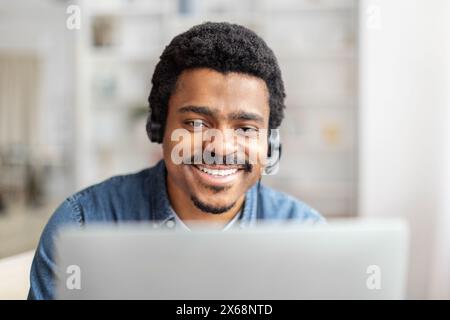 Friendly Customer Support Representative Working on Laptop in Bright Office Stock Photo