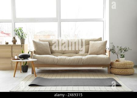 Interior of living room with sofa, yoga mat and glucophone Stock Photo