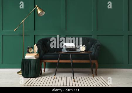 Interior of stylish living room with sofa and vintage typewriter on table Stock Photo