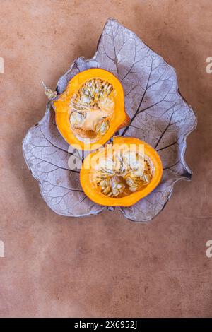 Two halves of raw organic pumpkin with seeds, Food-Stilllife Stock Photo