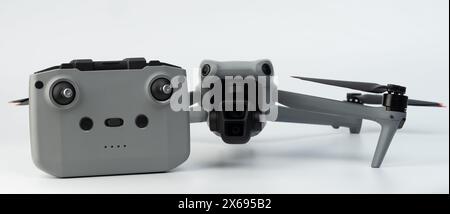 Gray UAV drone unfolded with remote control front view isolated Stock Photo