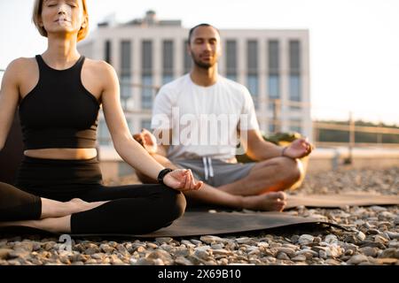 Close up view of hands on knees of young couple in sportswear. Stock Photo