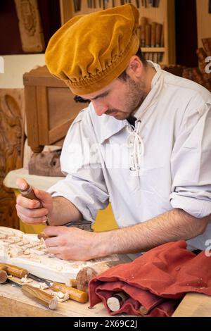 A wood craftsman, making a sample of his work, during the medieval market held in the town of El Álamo (Madrid), Spain, during the day May 4, 2024 Stock Photo