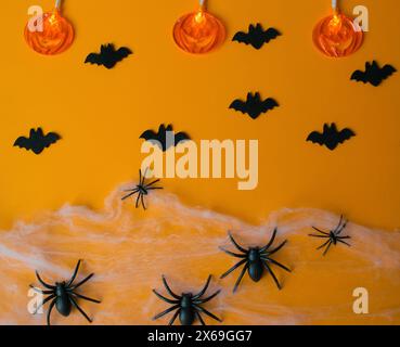 Halloween decorations, pumpkins, bats, web, bugs on orange background. Party greeting card. Stock Photo