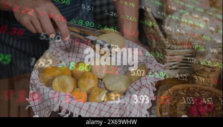 Image of changing numbers and graphs over midsection of caucasian man with small breads Stock Photo