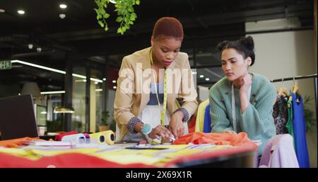 African American and biracial young professionals are examining fabric samples Stock Photo