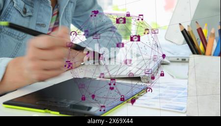 Person in denim jacket draws on tablet, with a digital interface floating above Stock Photo