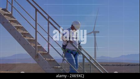 Image of financial data processing over wind turbine Stock Photo