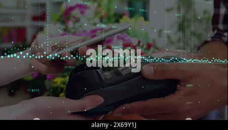 Image of soundwaves with numbers over cropped hands scanning qr code over credit card reader Stock Photo