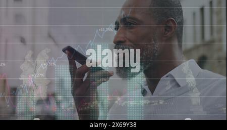 A black man is standing on a city street, using his smartphone Stock Photo