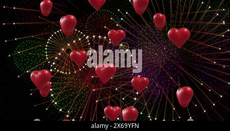 Image of red hearts over fireworks on black background Stock Photo
