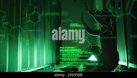 Image of computer language, molecule structures, caucasian man using vr headset in server room Stock Photo