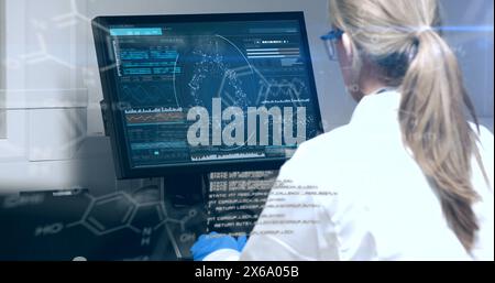 Image of data processing over caucasian senior female scientist using computer at laboratory Stock Photo