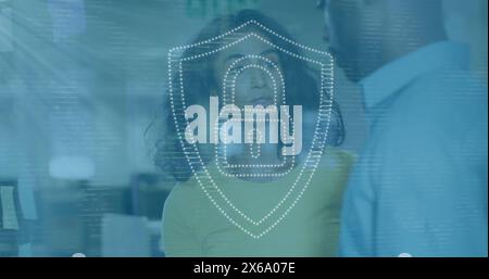 Image of dots forming padlock in shield over diverse coworkers discussing in office Stock Photo