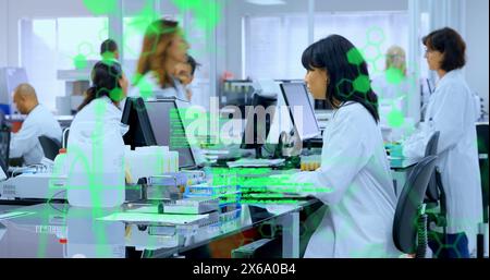 Image of data processing over biracial senior female scientist using computer at laboratory Stock Photo