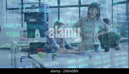 Image of trading board over diverse female architects discussing blueprint in office Stock Photo