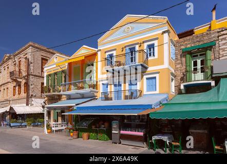 Picturesque row of brightly colored houses along waterfront promenade of Symi Island, Greece Stock Photo