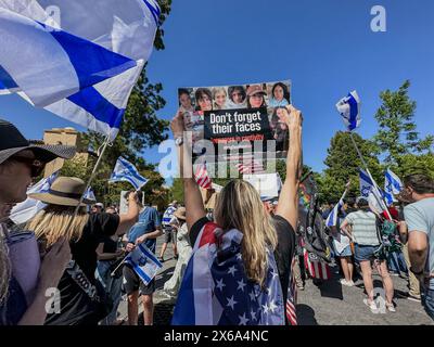 Palo Alto, California, U.S.A. 12th May, 2024. Israel and American flags flying and a Jewish woman holding a sign, 'Don't forget their faces: teenagers in captivity'', and as Hundreds of Jews are joined by Hindus, Muslims, Chinese and other allies at a Counter-Rally at Stanford University on Israel Independence Day and Mother's Day at an Interfaith rally organized by a Jewish student group. This was at the far end of White Square, where Pro-Palestine Protestors have set up a tent encampment and were holding a rally where they called for 'Intifada'' against Israel, made fun of the Jews Stock Photo