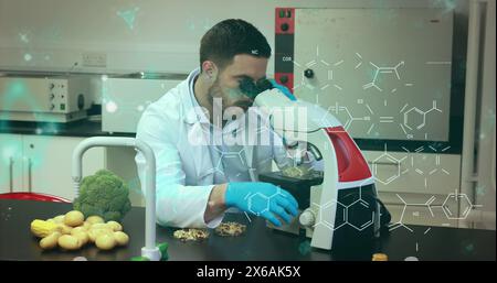 Image of molecule structures, nucleotides, caucasian scientist looking sample through microscope Stock Photo