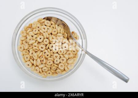 Loops cereals served in glass bowl with spoon on white Stock Photo