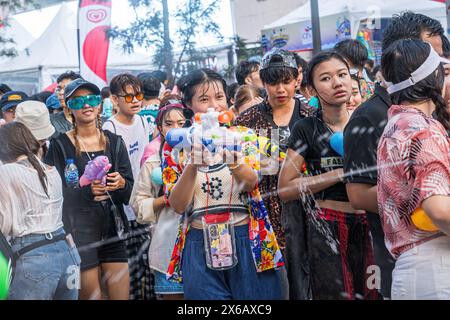 Siam Square, Bangkok, Thailand - APR 13, 2024 Songkran Festival, The short action of people joins celebrations of the Thai New Year or Songkran in Sia Stock Photo